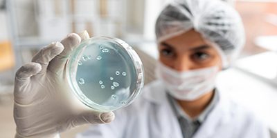 Woman Scientist Holding Dish